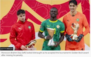 BBC/Getty ImagesMorocco’s Brahim Díaz (left) looks distraught as he accepts the tournament’s Golden Boot award after missing his penalty